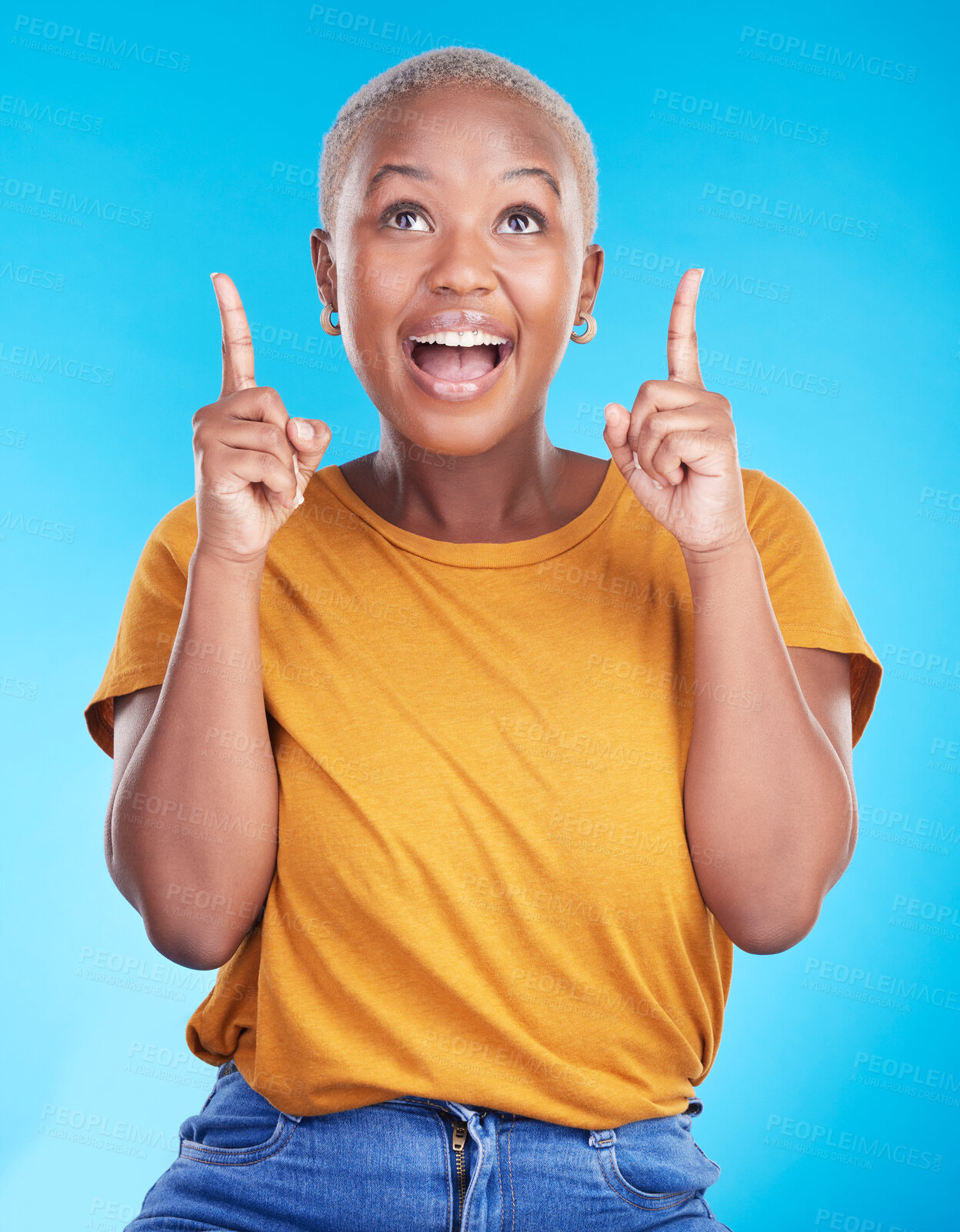 Buy stock photo Excited, pointing up and happy black woman with studio advertising space, retail promotion news or announcement. Smile, brand notification and African person gesture at sales deal on blue background