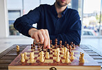 Chess, man moving a knight and game of strategy, problem solving or person playing on chessboard in competition. Planning, choice and hand on piece or king, queen and player thinking of winning move