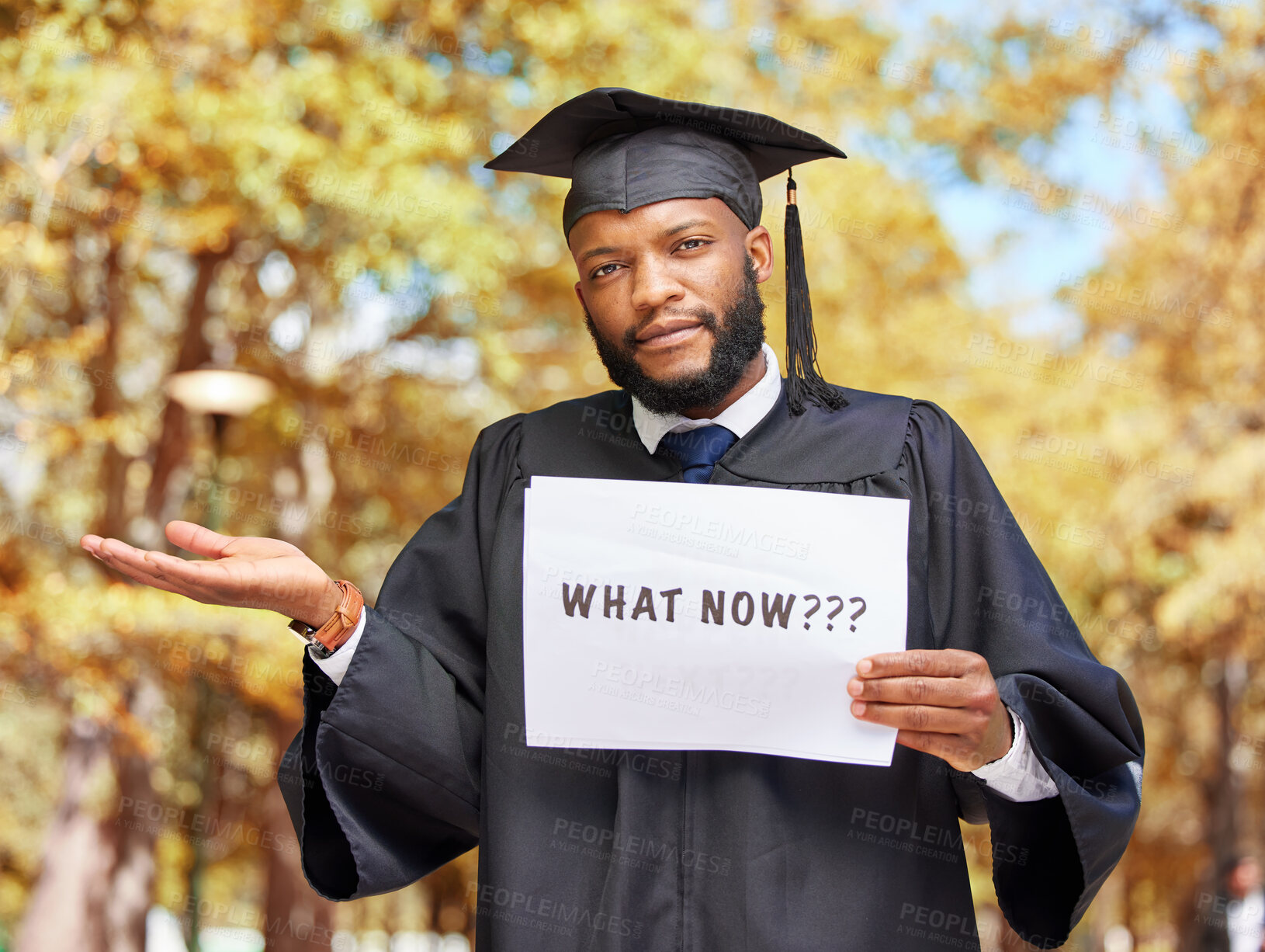 Buy stock photo Paper sign, graduation and portrait of a man in a garden by his college campus with a confused gesture. Doubt, graduate and African male student with poster and shrug expression outdoor at university