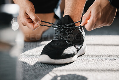 Buy stock photo Exercise, shoes and tie laces with a man in a sports gym getting ready for a cardio or endurance workout. Fitness, running and preparation with a male athlete or runner at the start of training