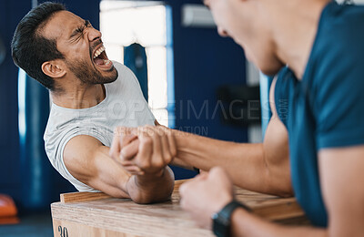 Buy stock photo Strong, loser or men arm wrestling at gym on a table in playful challenge together in fitness training. Game, pain or strong people in muscle power battle for sports, hard competition or tough match