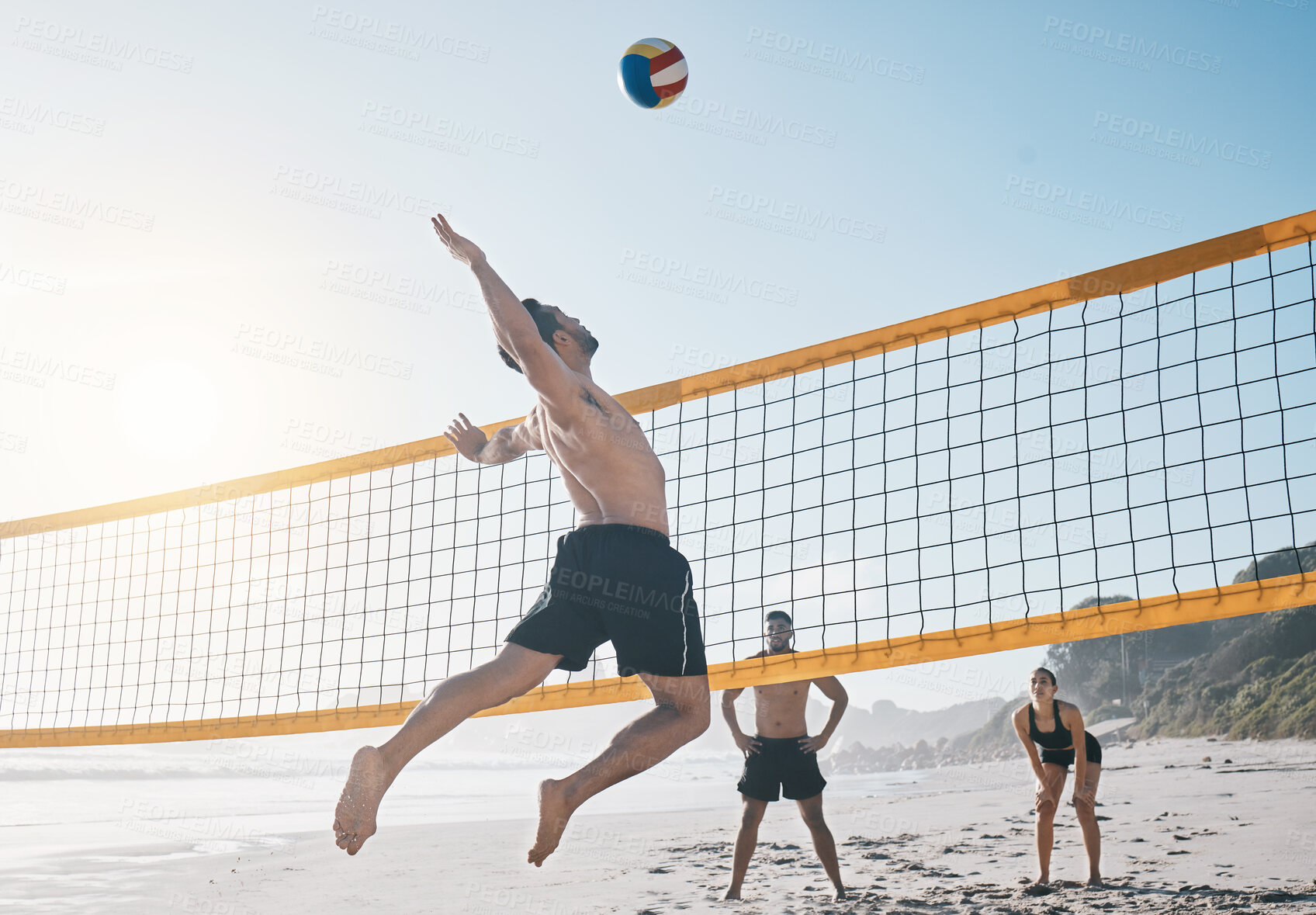 Buy stock photo Man, jump and volleyball in air on beach by net in sports match, game or competition. Body of male person jumping for ball in volley or spike in healthy fitness, energy or exercise by the ocean coast