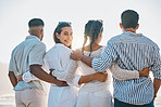 Happy friends, back and hug on beach for holiday, vacation or weekend together in nature. Rear view of group or people standing for quality bonding time, trip or travel by the ocean coast outside