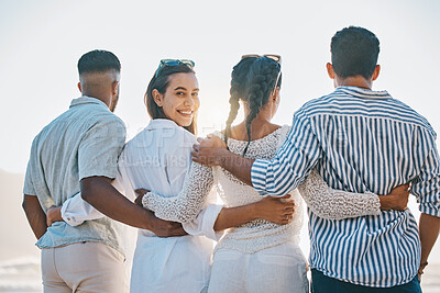Buy stock photo Happy friends, back and hug on beach for holiday, vacation or weekend together in nature. Rear view of group or people standing and bonding in community, support or trust by the ocean coast outside