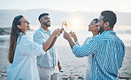 Friends, smile and toast with champagne on beach, having fun and bonding at sunset. Ocean, group and people cheers with wine glass, alcohol and drink for celebration on holiday, summer party and sea.