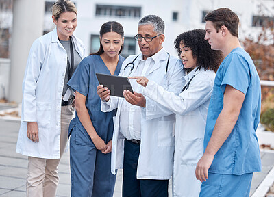 Buy stock photo Tablet, doctors and medical people at hospital outdoor with clinic management, research and online teamwork. Group, telehealth and healthcare staff, nurses and mentor with digital technology training
