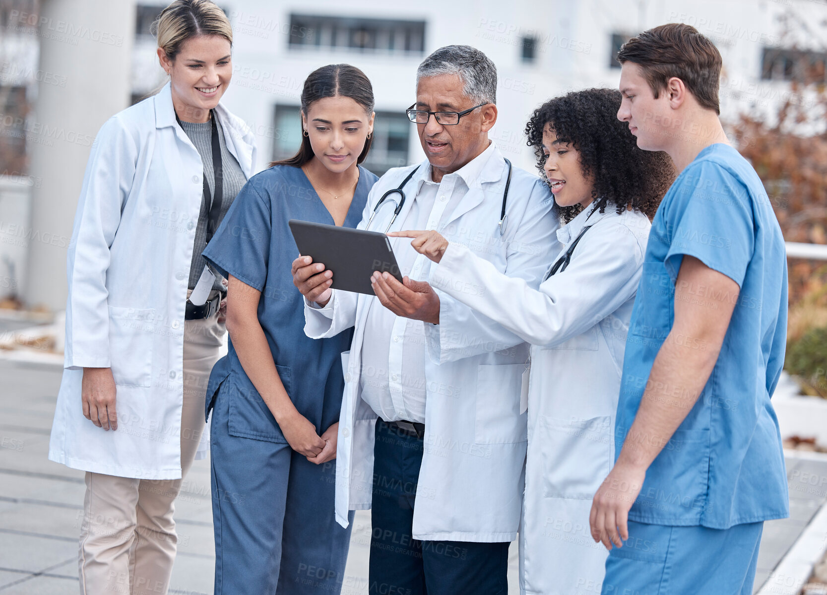 Buy stock photo Tablet, doctors and medical people at hospital outdoor with clinic management, research and online teamwork. Group, telehealth and healthcare staff, nurses and mentor with digital technology training
