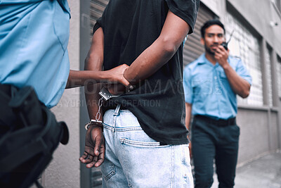 Buy stock photo Criminal, handcuffs and arrest with security officer or radio at property for protection or safety. Police, patrol and crime and guy going to jail for robbery, drugs or stealing in street with tech.