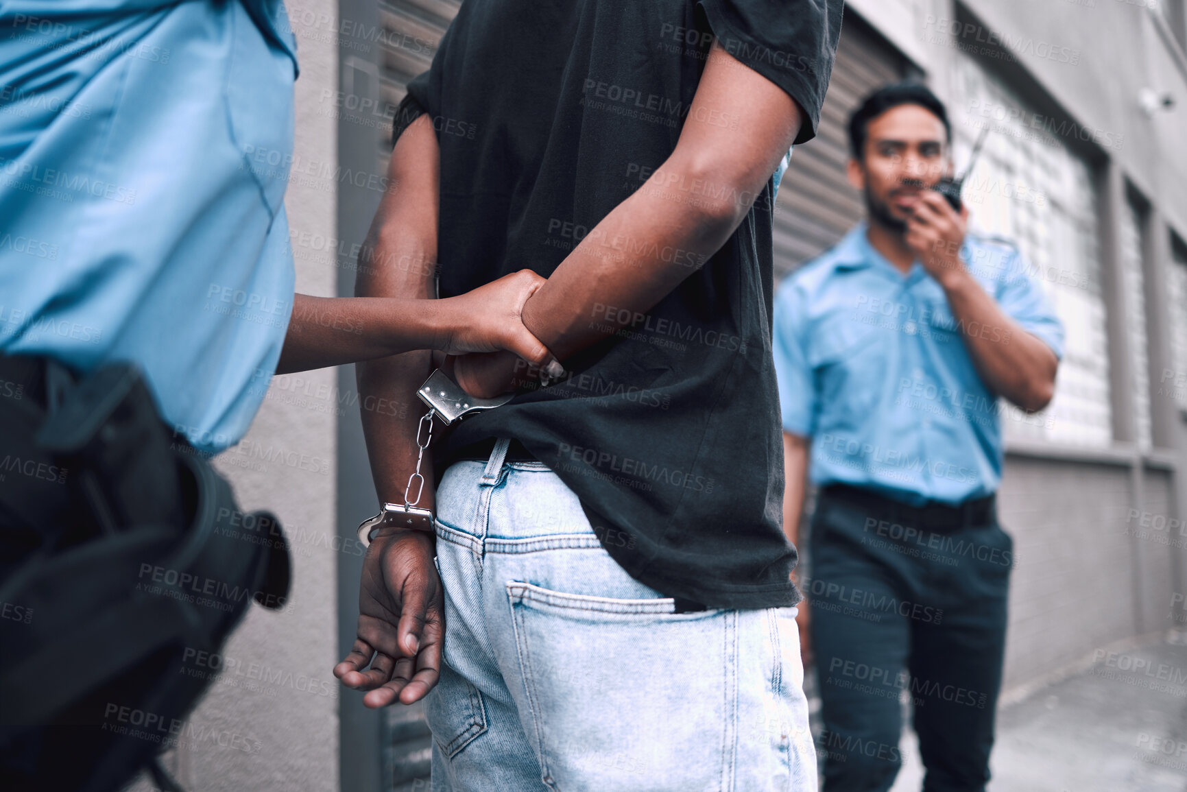 Buy stock photo Criminal, handcuffs and arrest with security officer or radio at property for protection or safety. Police, patrol and crime and guy going to jail for robbery, drugs or stealing in street with tech.