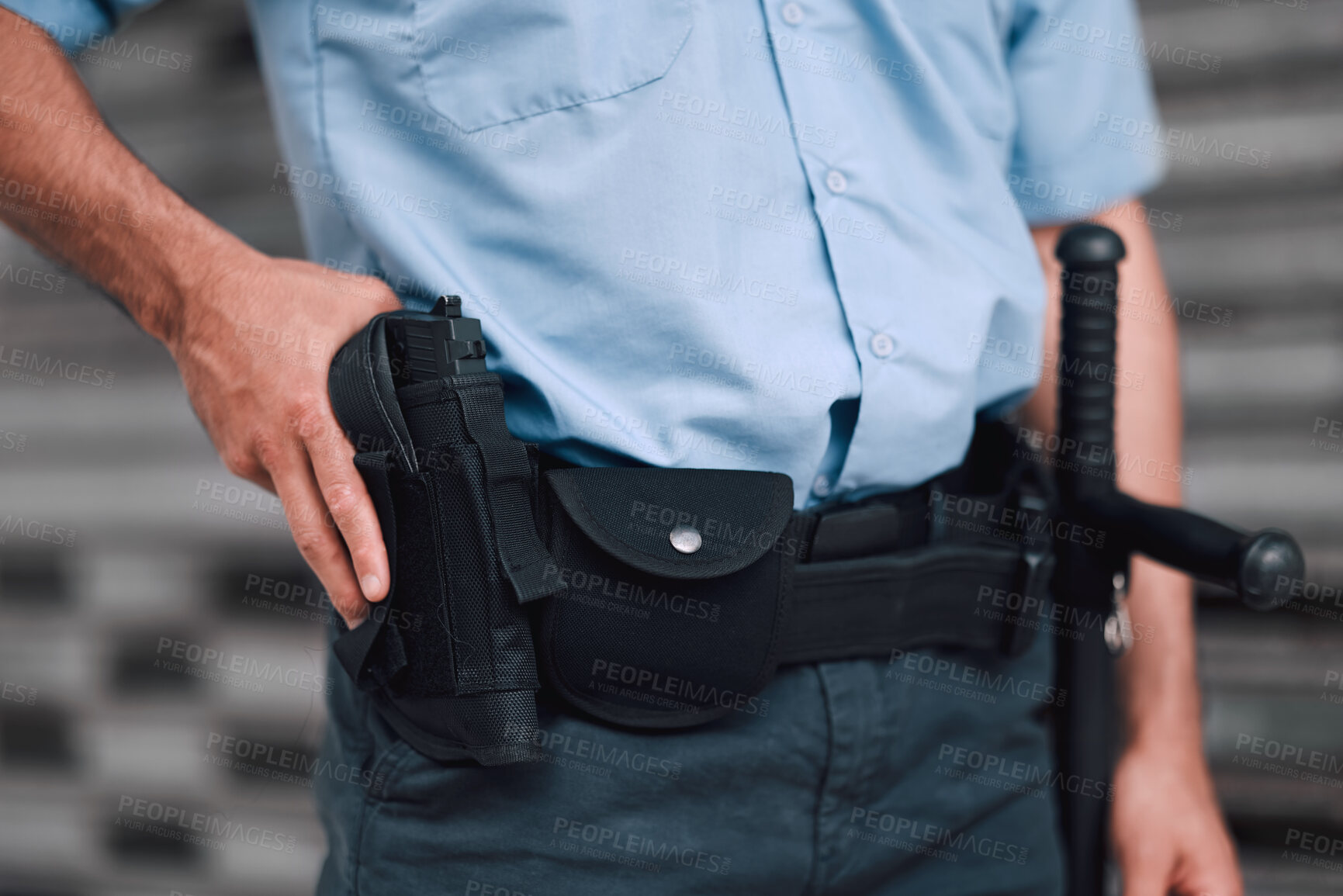 Buy stock photo Hand, gun and security with an officer on duty or patrol in the city for safety and law enforcement. Police, service and armed response with a guard outdoor in an urban town for crime prevention