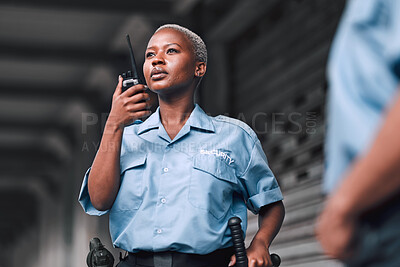 Buy stock photo Police, communication and black woman law enforcement worker talking on walkie talkie or radio for emergency. Security, legal and officer or employee doing criminal investigation for justice