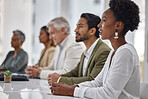 Diversity, corporate and black woman in a meeting or business conference for company development or growth. Listening, workshop and group or row of employees in training presentation for teamwork