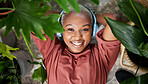 Headphones, portrait and woman listening to music to relax with plants for peace and calm. Face of a happy black female person streaming sound, audio and podcast or radio online with a smile at home