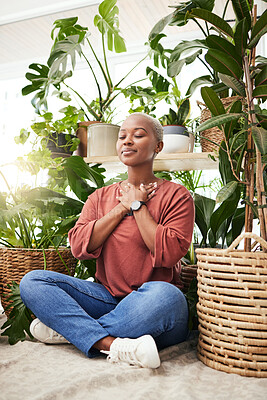 Buy stock photo Meditation, plant and black woman relax in home for wellness, zen mindset and calm energy. Nature, happy and face of female person meditate on floor with eco friendly ferns, leaves and house plants