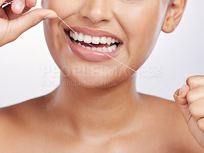 Buy stock photo Mouth, face and woman floss teeth for dental health, care or gingivitis on studio background. Closeup of female model, oral thread and cleaning string for fresh breath, tooth hygiene or healthy habit
