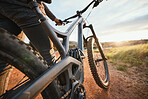 Sports, mountain bike and closeup of bicycle in nature for hobby, workout and exercise in countryside. Fitness, cyclist and person cycling for adventure, freedom and adrenaline on outdoor dirt road