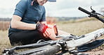 Injury, accident and a man with knee pain and a bike in nature after cycling or travel for fitness. Sports, cardio inflammation and a biker with a medical emergency on a bicycle in the countryside
