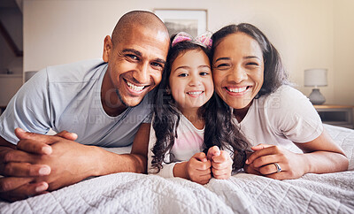 Buy stock photo Family, portrait and relax on a bed at home with a smile and comfort for quality time. Man, woman or hispanic parents and a girl kid together in the bedroom for morning bonding with love and care
