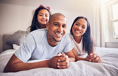 Buy stock photo Family, relax and happy portrait on a bed at home while happy and playing for quality time. Man, woman or hispanic parents and a girl kid together in bedroom for morning bonding with love and care
