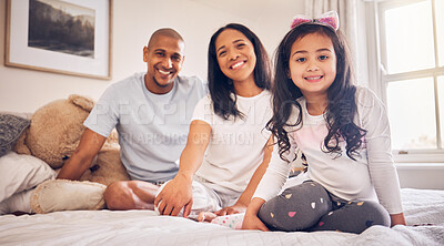 Buy stock photo Family, relax and happy portrait on a bed at home with a smile and comfort for quality time. Man, woman or parents and a latino girl kid together in the bedroom for morning bonding with love and care