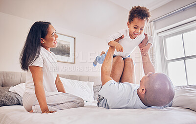 Buy stock photo Happy family, playing and dad with child on bed, bonding and airplane game for father and daughter time in home. Parents, love and playful energy, man holding girl in air and mom laughing in bedroom.