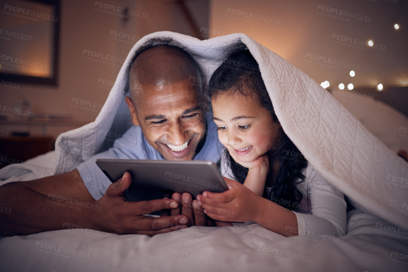 Buy stock photo Father, kid and smile with tablet at night under blanket of online games, reading ebook or storytelling app. Happy dad, girl child or watch cartoon movie on digital tech, media or internet in bedroom