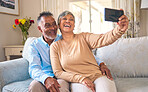 Senior couple, selfie and laughing at home for social media, network connection or memory. Mature man and woman together with smartphone for a profile picture with a smile and love on a lounge sofa