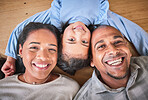 Face, family and smile in home top view, bonding and having fun on floor in house. Portrait, parents and happy child, mother and father with love, relax on ground and enjoying quality time together.
