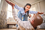 Family, fun and a daughter flying with dad on the floor of a living room in their home together for bonding. Smile, children and portrait a happy girl playing fantasy games her father in their house