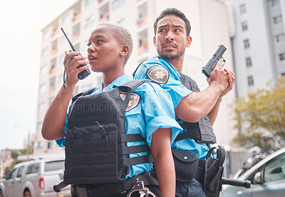 Buy stock photo Team, gun and police in the city for crime, talking into equipment and ready for action. Security, law and a black woman and man speaking into gear while in collaboration for criminal activity