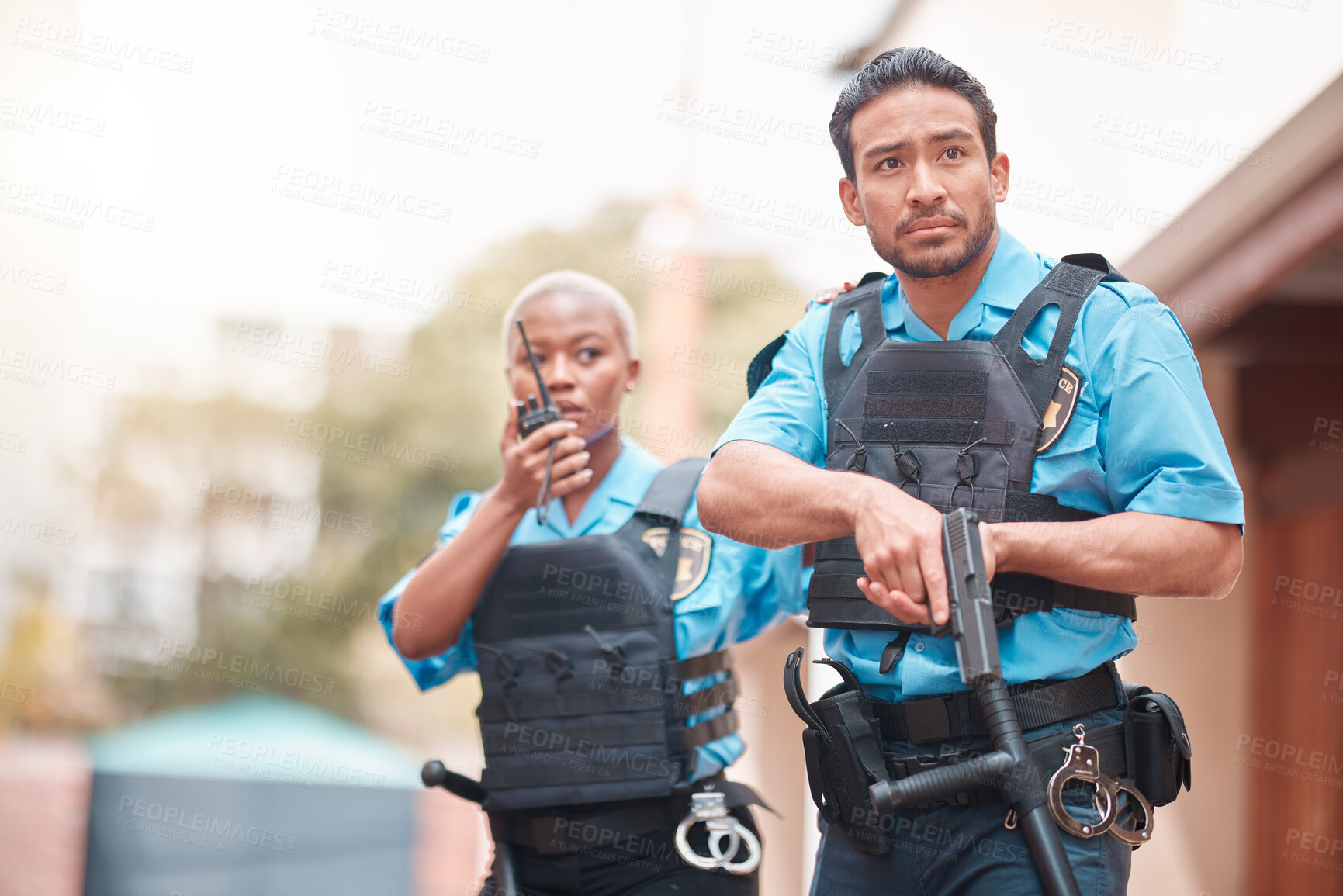 Buy stock photo Crime, team and police with an investigation together for security, law and neighborhood safety. Serious, teamwork and a black woman and a man with gear for search or help during an emergency