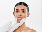 Injection, scared and portrait of woman with face filler of beauty process on white background in studio. Cosmetics, indian female model and fear of needle, plastic surgery or aesthetic facial change