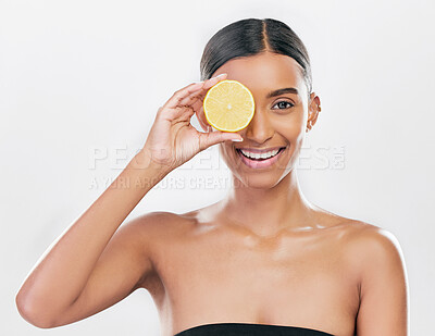 Buy stock photo Happy, lemon and portrait of a woman for skincare, beauty glow or vitamin c for health. Smile, wellness and an Indian model or girl with fruit for diet isolated on a white background in a studio