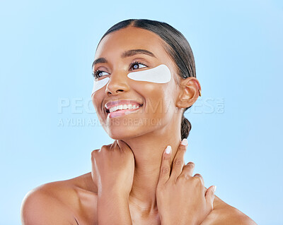 Buy stock photo Eye patch, face and beauty of a happy woman with natural skin glow on a blue background. Dermatology, collagen mask and cosmetics of Indian person for facial shine, wellness or self care in studio