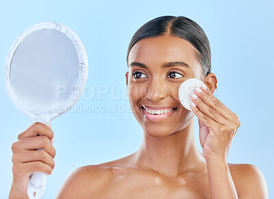 Buy stock photo Mirror, cotton and woman with beauty or skincare as cosmetic product treatment isolated in a studio blue background. Cleaning pad, exfoliate and young female person with clean face due to facial
