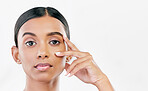 Beauty, hand on face and portrait of a woman with natural skin glow isolated on a white background. Dermatology, makeup and cosmetics of Indian female model for facial shine or self care in studio