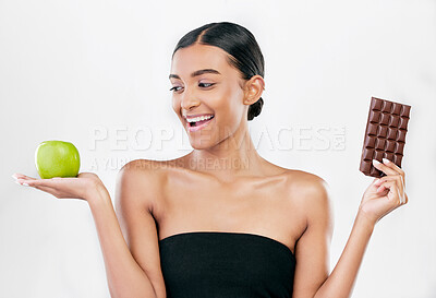 Buy stock photo Apple, chocolate and happy woman for healthy food choice, sugar and skincare isolated on studio, white background. Dessert, green fruit and african person detox, vegan beauty or dermatology decision