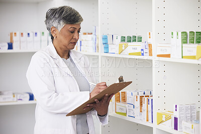 Buy stock photo Pharmacist, medicine and a woman writing on a clipboard in a pharmacy for inventory or checklist. Mature female employee check shelf for management in healthcare, pharmaceutical and medical industry