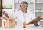 Woman, doctor and box at pharmacy for inventory inspection, logistics or delivery at drug store. Senior female person, medical or healthcare professional checking pharmaceutical stock or medication