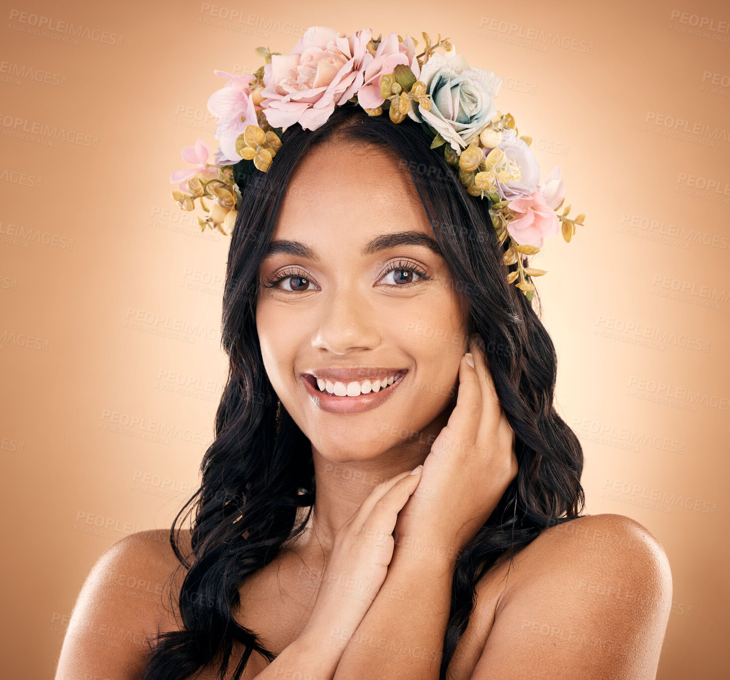 Buy stock photo Portrait, smile and flower crown with a model woman in studio on a brown background for shampoo treatment. Beauty, salon and hair with a happy young person looking confident about natural cosmetics