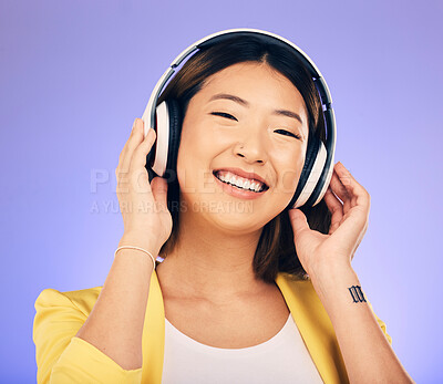 Buy stock photo Headphones, music and happy Asian woman in studio listening to audio, streaming song and radio. Entertainment, subscription and female person relax with earphones for album on purple background