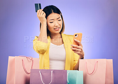 Buy stock photo Woman, confused and credit card, phone and online shopping  scam, news or fintech payment problem. Stress, retail bag and sad asian person in e commerce mistake on mobile and purple studio background