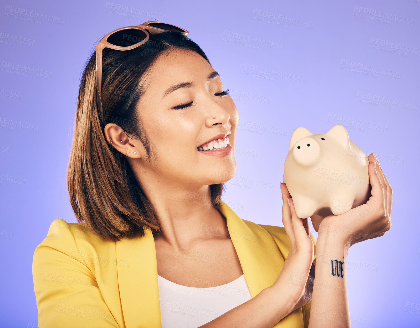 Buy stock photo Piggy bank, finance and woman thinking of savings, investment and happy for money growth goals. Young asian person for financial management, money safe or banking security on studio purple background