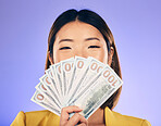 Money, beauty and woman cover face on purple studio background for winning, cash fan or financial prize. Lottery, bank and asian person or winner bonus, cosmetics secret or finance profit in portrait