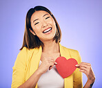 Girl, smile and heart for care in portrait for purple background in studio with asian on valentines day. Support, love and chest with female person with happiness with emoji shape or emotion.