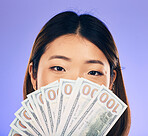 Money, winner and woman cover face on purple, studio background for winning, cash fan or financial loan. Lottery, bank and asian person or winner bonus, budget secret and finance profit in portrait