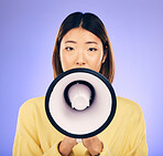 Woman, megaphone and portrait in studio for announcement, voice or broadcast. Face of a young asian female speaker with a loudspeaker for communication, sad message or speech on purple background