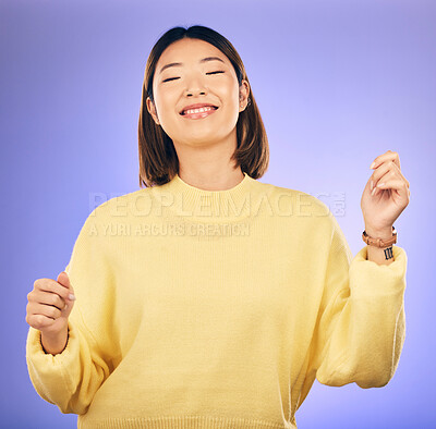 Buy stock photo Happy asian woman, dancing and music in freedom or casual fashion against a purple studio background. Female person or model smile enjoying energy, event or party in happiness for clothing style
