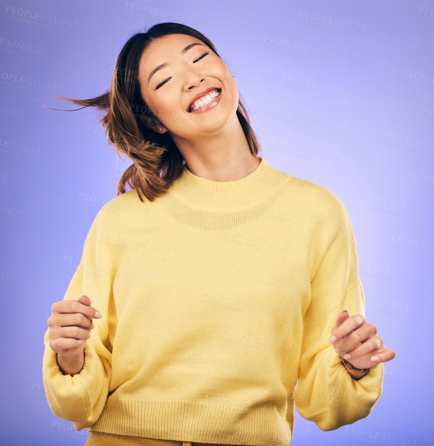 Buy stock photo Happy asian woman, dancing and enjoying music, freedom or casual fashion against a purple studio background. Female person or model smile for energy, event or party in happiness for clothing style