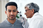 Ear check, woman and doctor with patient consultation for hearing and wellness at hospital. Senior, employee and otoscope test of physician with health insurance and consulting exam with expert
